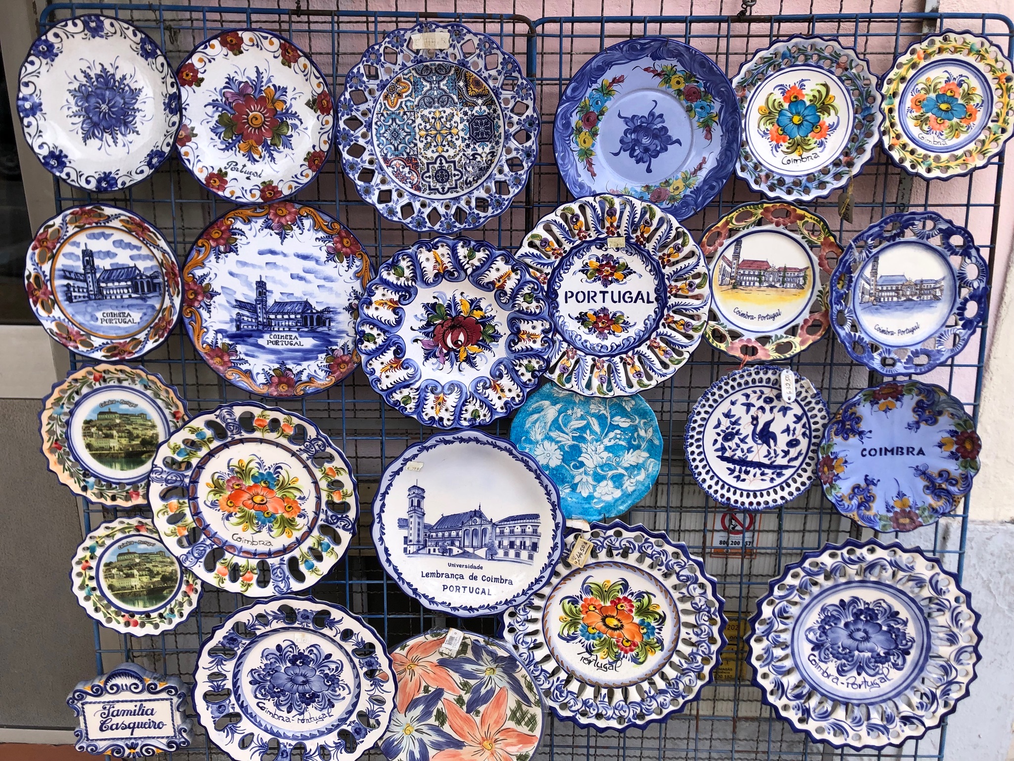 An image of beautifully painted ceramic plates in the Portuguese azulejo style with the names of cities and regions of Portugal